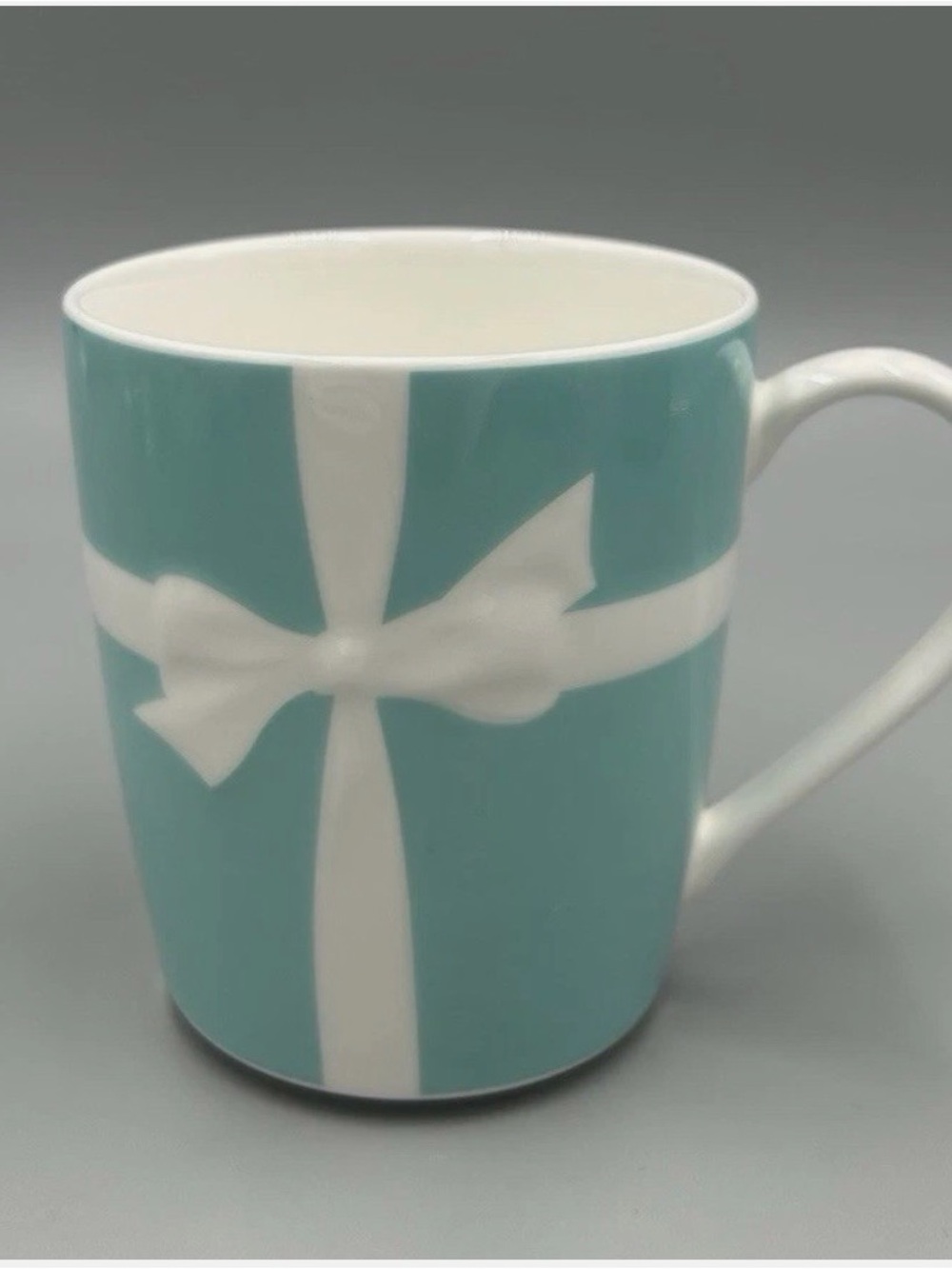 Tiffany & Co. Blue Ceramic Mug with White Bow Design